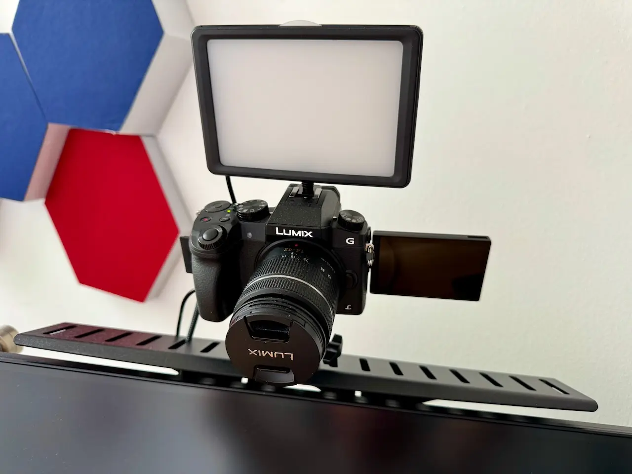 An image of a Lumix G7 on a VESA mount and an LED light